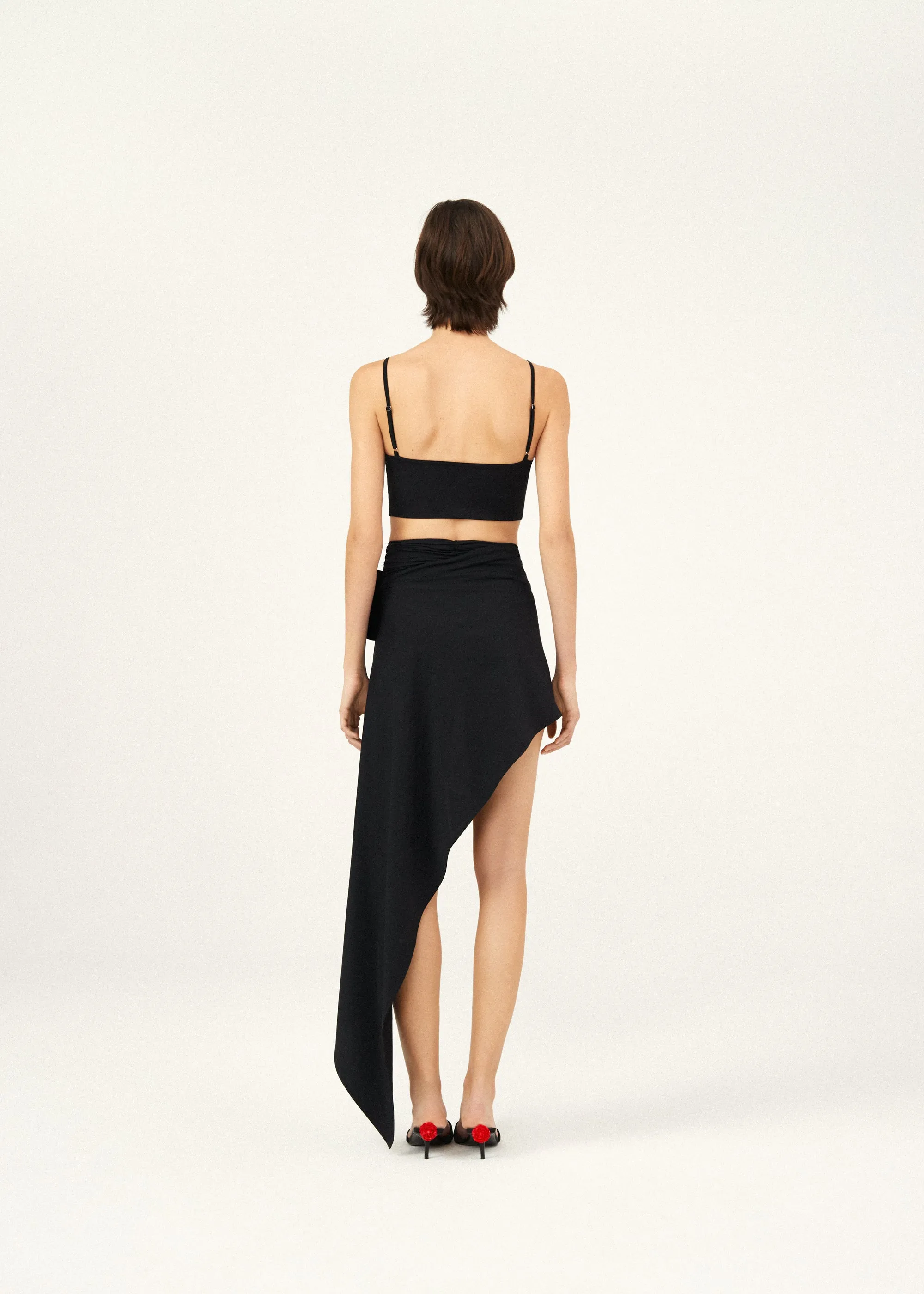 Asymmetrical draped swim skirt in black